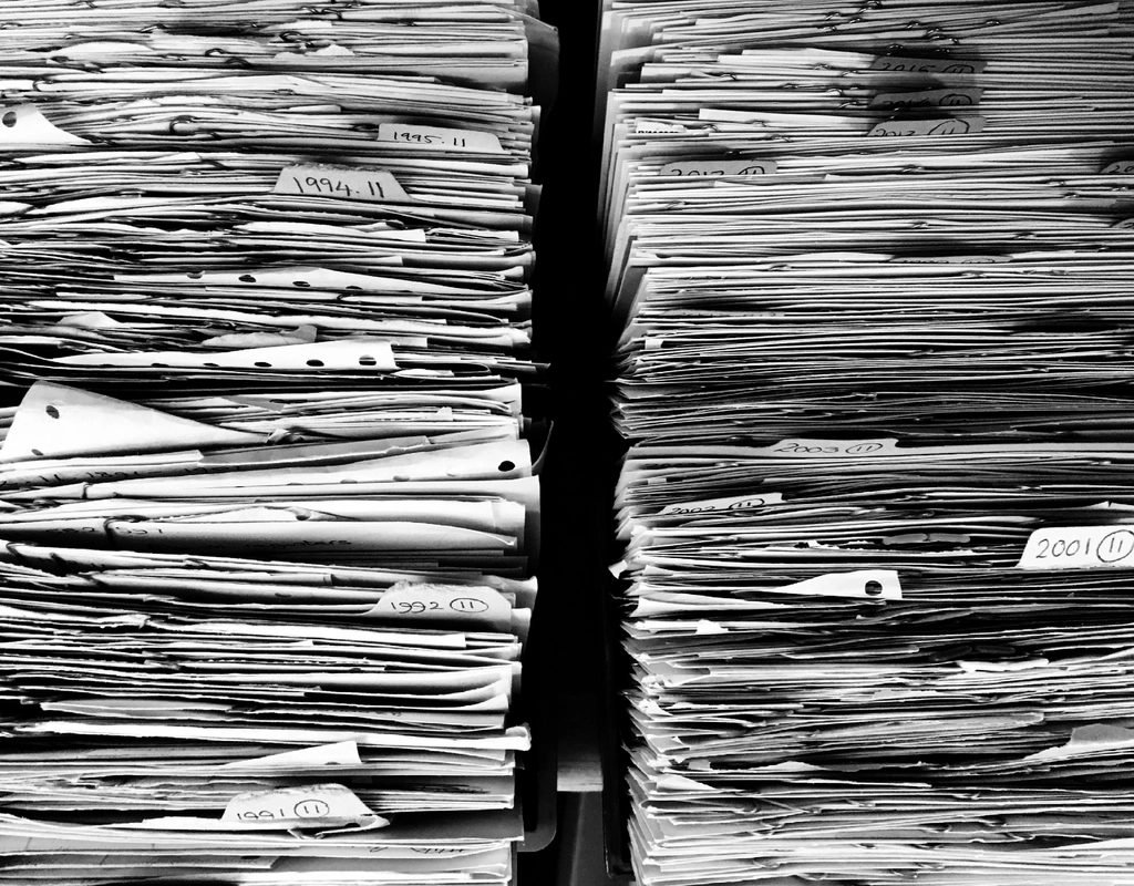 Neatly stacked piles of paper documents representing files ready to merge, split or convert